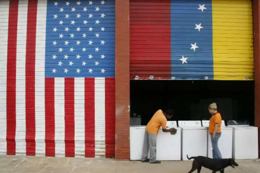 Vendors prepare products at a store painted with Venezuelan and U.S. flags in Maracaibo (Stringer/Courtesy Reuters).