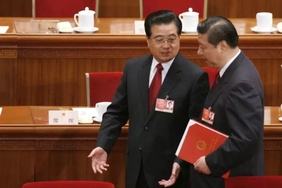 China's President Hu Jintao talks to Vice President Xi Jinping after the closing ceremony of the National People's Congress at the Great Hall of the People in Beijing on March 13, 2009.