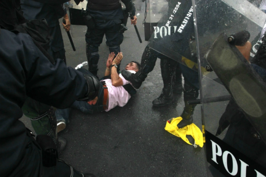 Thai riot police detain an anti-government protester during a rally in Bangkok November 24, 2012. In “Democracy of Retreat?...lations and Yale University Press, Joshua Kurlantzick examines the regression of democracy in Thailand, among other countries.