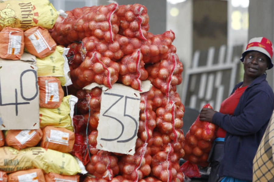 A vegetable vendor waits for customers at her stall in Kliptown, Soweto February 15, 2010 (Siphiwe Sibeko/Courtesy Reuters).