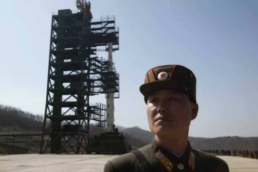 A soldier stands guard in front of the Unha-3 (Milky Way 3) rocket sitting on a launch pad at the West Sea Satellite Launch Site, during a guided media tour by North Korean authorities in the northwest of Pyongyang. (Bobby Yip/Courtesy Reuters)