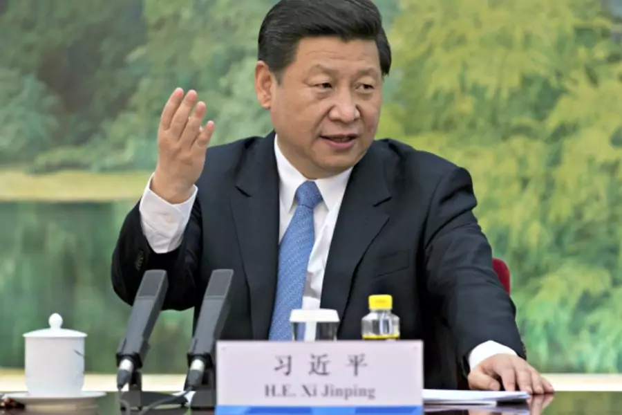 China's newly appointed leader Xi Jinping attends a meeting with foreign experts at the Great Hall of the People in Beijing on December 5, 2012.