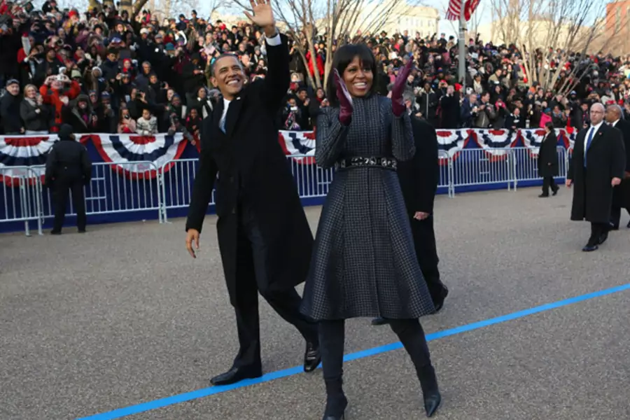 President Barack Obama and First Lady Michelle Obama wave to supporters during the inaugural parade in Washington on January 21, 2013 (Doug Mills/Courtesy Reuters).