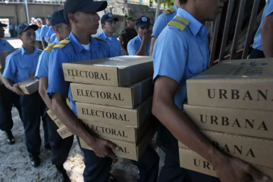 Nicaraguan police carry ballot boxes, which will be used for the upcoming presidential election, in Managua