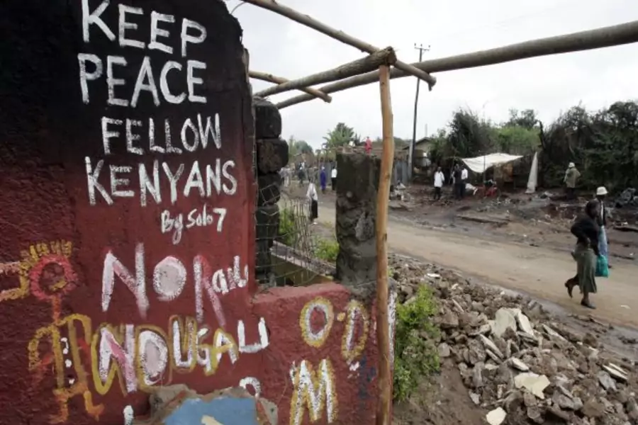 Kenyans walk past a destroyed house in the sprawling Kibera slums, which was one of the most affected areas during the post-election violence in 2007 (Antony Njuguna/Courtesy Reuters).