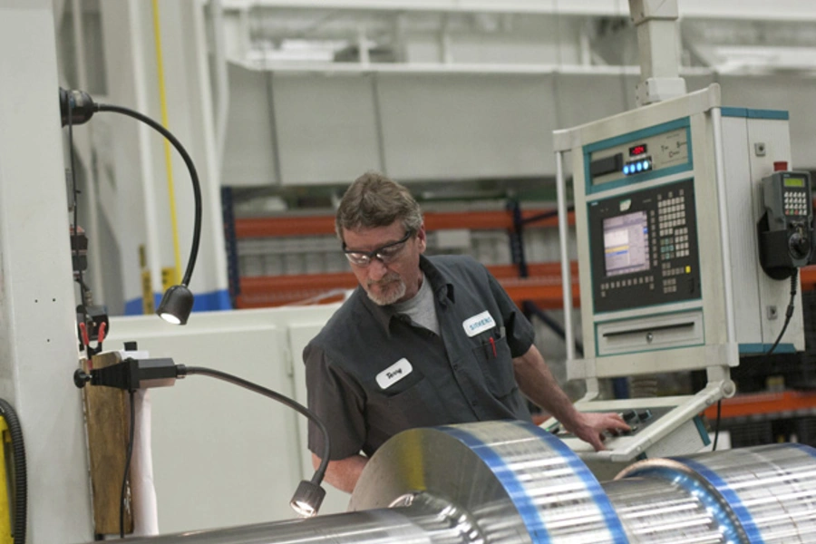 An employee works on a component for a turbine at the Siemens Energy plant in Charlotte, North Carolina (Chris Keane/Courtesy Reuters).