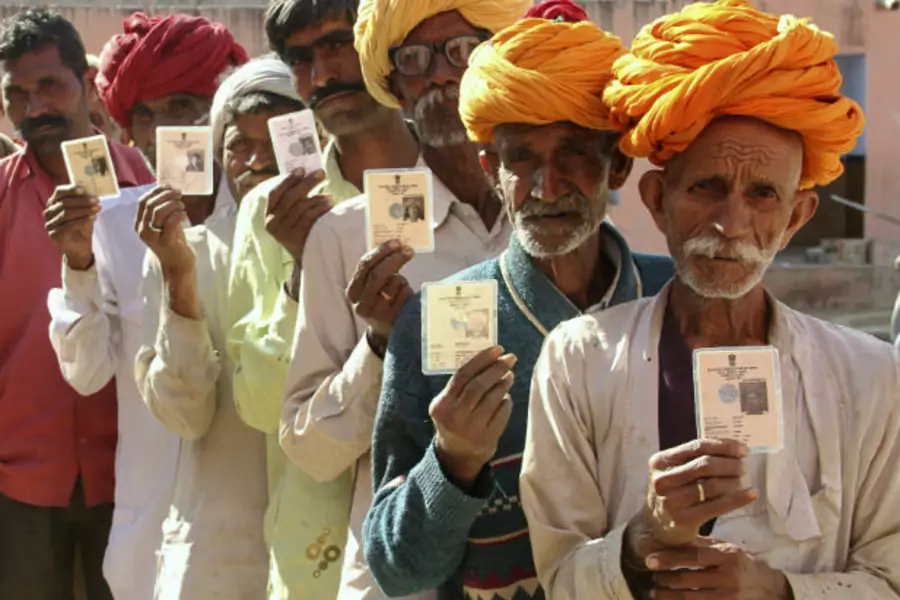 illagers pose with their identity cards as they stand in line to open a bank account at a camp organised by a private bank in a village at Ajmer in the desert Indian state of Rajasthan on January 10, 2013 (Courtesy Reuters).