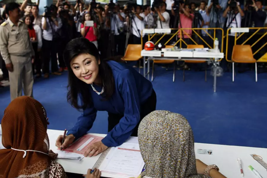 Thailand's prime minister Yingluck Shinawatra prepares to cast her ballot in the election for Bangkok's governor in a polling station in Bangkok March 3, 2013.