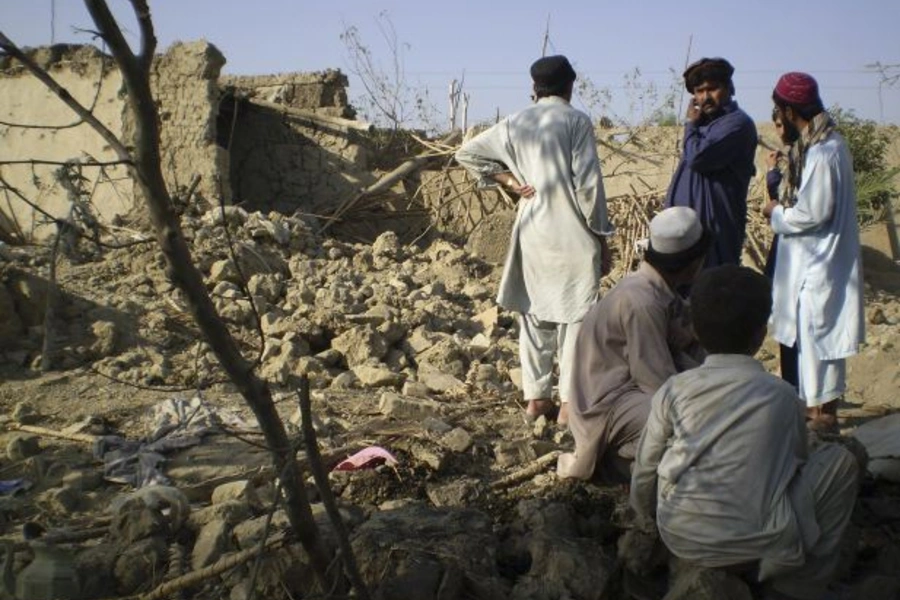 Tribesmen gather at a site of a suspected drone strike on the outskirts of Miranshah, Pakistan, near the Afghan border in October 2008 (Haji Mujtaba/Courtesy Reuters).