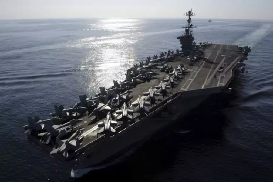 The aircraft carrier USS John C. Stennis transits the Straits of Hormuz (Handout/Courtesy Reuters).