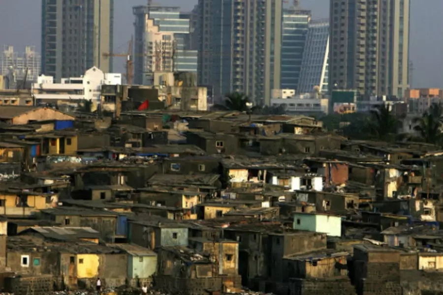 High rise buildings are seen behind a slum in Mumbai on April 28, 2009 (Arko Datta/Courtesy Reuters).