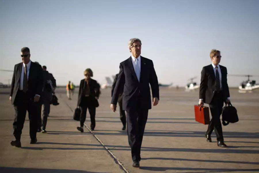 Secretary of State John Kerry walks across the tarmac of Baghdad International Airport on a March visit to Iraq (Jason Reed/Courtesy Reuters).