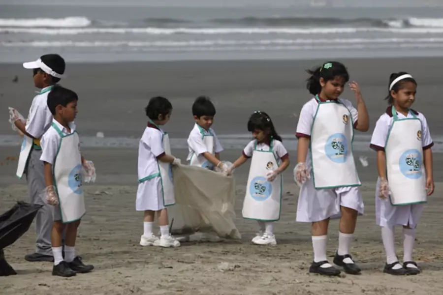 Children in Karachi, Pakistan, clean up a beach for Earth Day 2013 (Akhtar Soomro/Courtesy Reuters).