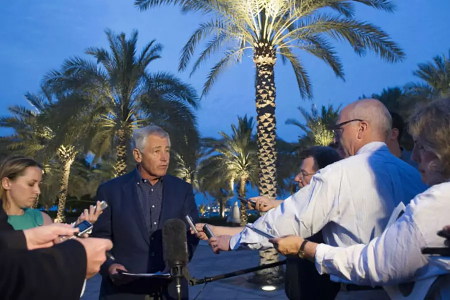 U.S. secretary of defense Chuck Hagel speaks with reporters in Abu Dhabi after reading a statement on chemical weapon use in Syria (Jim Watson/Courtesy Reuters).