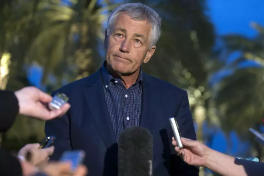 U.S. Secretary of Defense Chuck Hagel speaks with reporters after reading a statement on chemical weapon use in Syria during a news conference in Abu Dhabi. (Jim Watson/Courtesy Reuters).