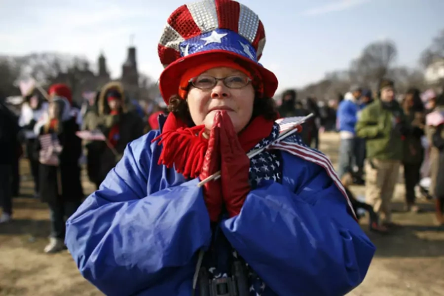 An attendee prays during the inauguration ceremony of Barack Obama as the 44th president of the United States (Shannon Stapleton/Courtesy Reuters).