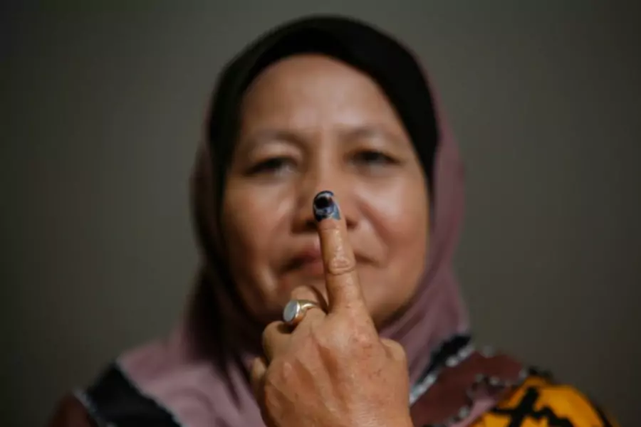 A voter shows her inked finger after casting her vote during the general elections in Malaysia on May 5, 2013.