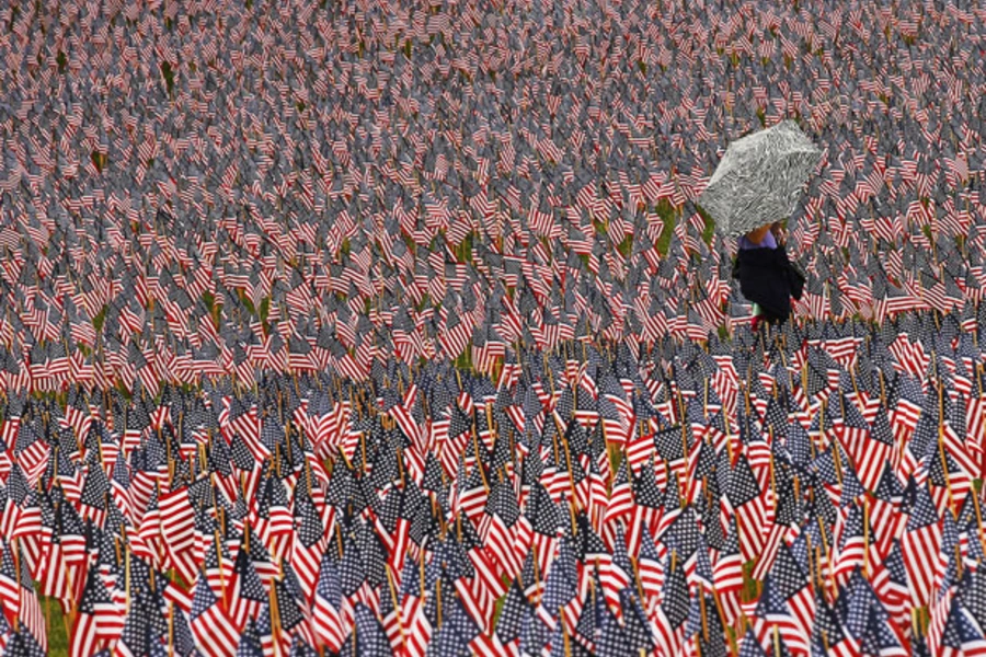 A pedestrian walks through a Memorial Day display of American flags on the Boston Common (Brian Snyder/Courtesy Reuters).