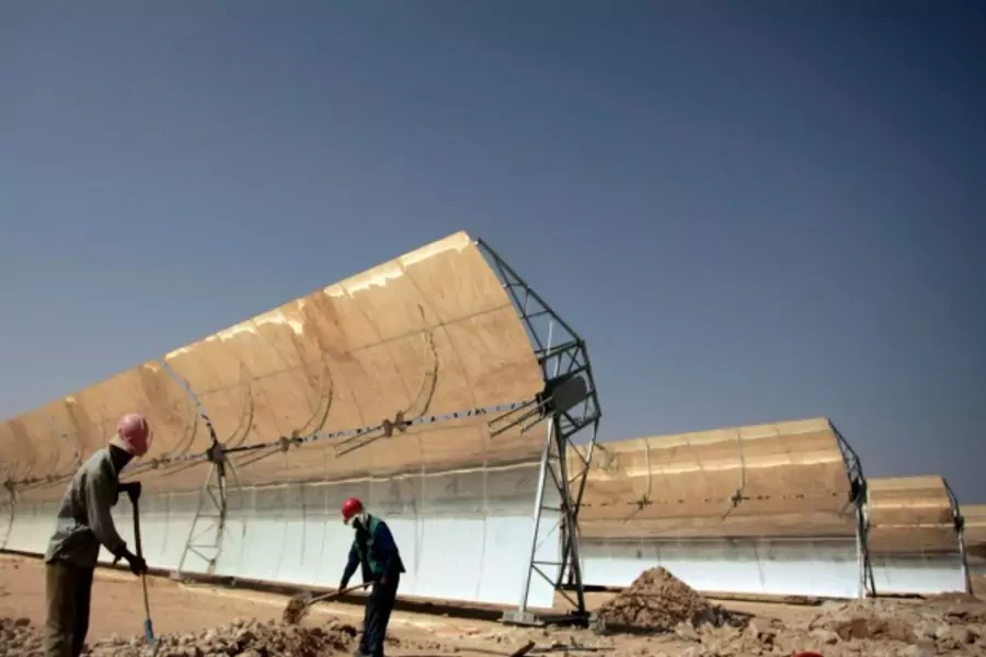 Workers build a thermo-solar power plant in Ain Beni Mathar, Morocco, 2009 (Courtesy Reuters).