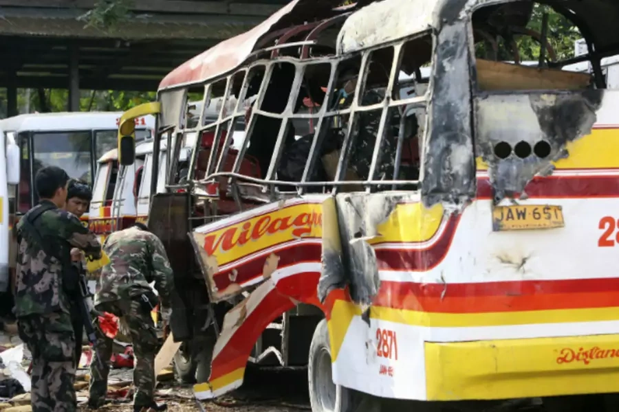Police and military bomb experts search for fragments and residue after a bomb exploded and ripped through a passenger bus, ki...at has already killed more than a hundred and left scores of others wounded, local media reported. (Stringer/Courtesy Reuters)