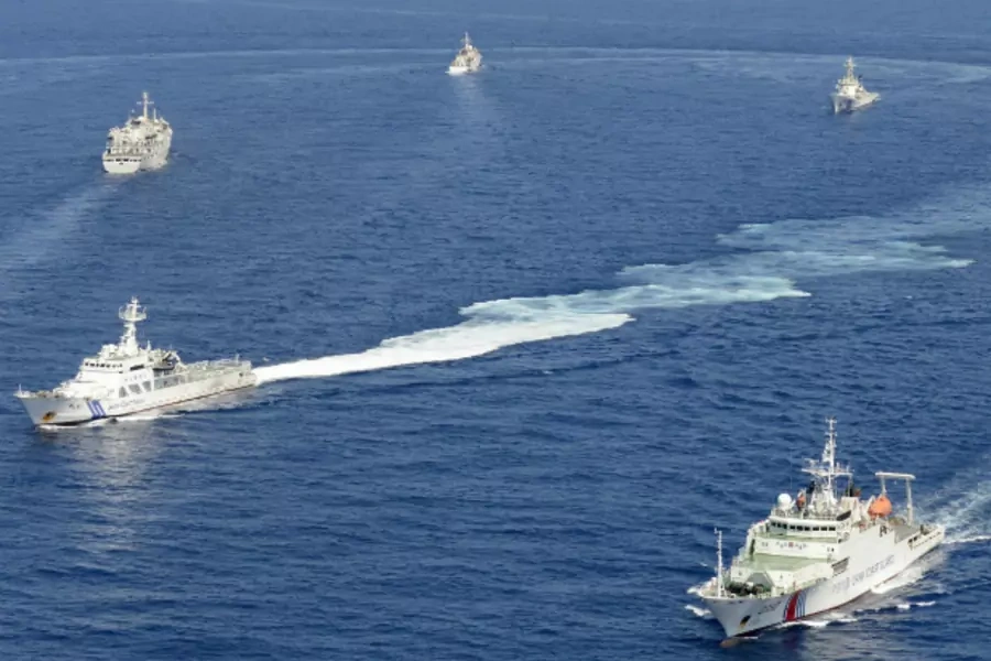 Vessels from the China Maritime Surveillance and the Japan Coast Guard are seen near disputed islands, called Senkaku in Japan and Diaoyu in China, in the East China Sea, in this photo taken on September 10, 2013. (Kyodo/Courtesy Reuters)