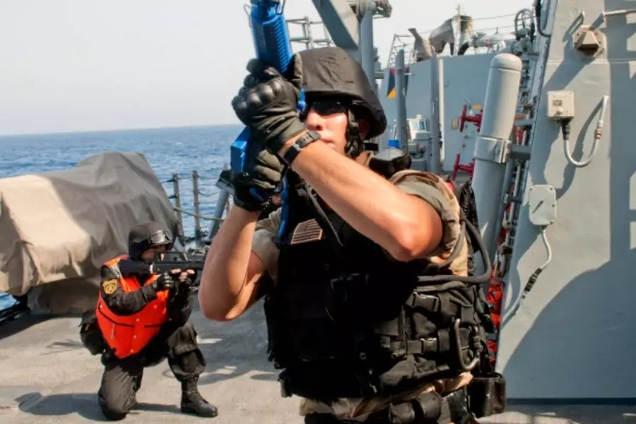 A visit, board, search and seizure member checks his surroundings aboard the guided-missile destroyer USS Winston S. Churchill...ng in the Gulf of Aden on September 17, 2012 (U.S. Navy/Mass Communication Specialist 2nd Class Aaron Chase/Courtesy Reuters).