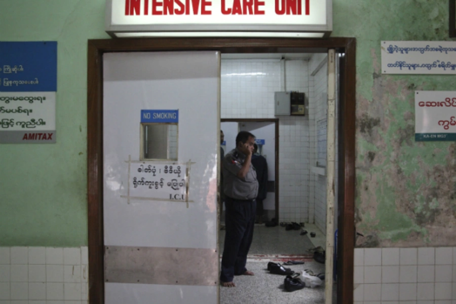 A policeman stands inside the intensive care unit (ICU) room where a American woman injured during the Traders Hotel bomb blast is receiving treatment at Yangon General Hospital in Yangon on October 15, 2013. (Courtesy Reuters)