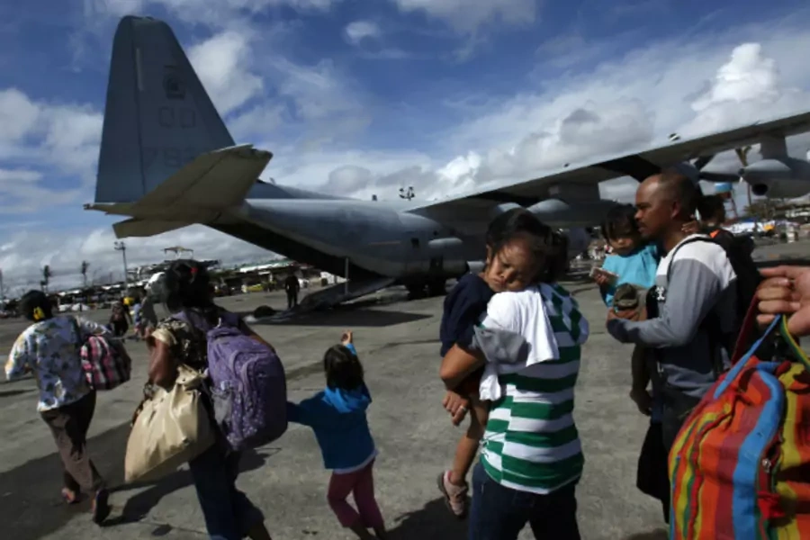 Evacuated residents prepare to get onto a U.S. military plane at Tacloban airport in central Philippines on November 13, 2013, five days after Typhoon Haiyan devastated the area. (Bobby Yip/Courtesy Reuters)