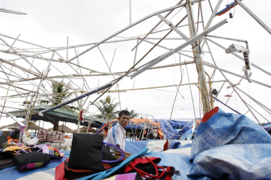 A man sits at his damaged shop in the aftermath of typhoon Haiyan in Vietnam's northern Quang Ninh province, 180 km (112 miles) from Hanoi on November 11, 2013. (Nguyen Huy Kham/Courtesy Reuters)