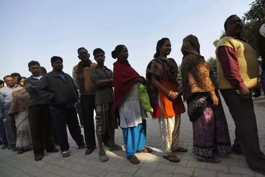 Voters line up outside a polling booth during the state assembly election last week in New Delhi, India. (Ahmad Masood/Courtesy Reuters)