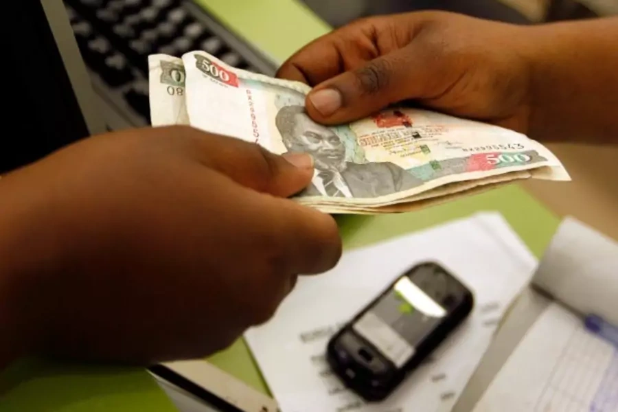 A customer conducts a mobile money transfer, known as M-Pesa, in Nairobi, Kenya, July 2013 (Courtesy Reuters/Thomas Mukoya).