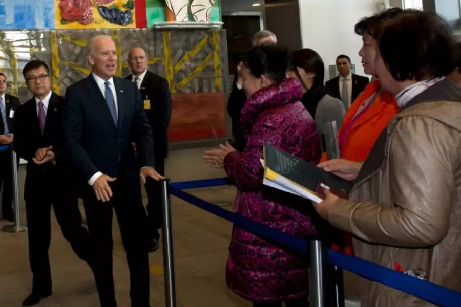 U.S. Vice President Joe Biden (C) and U.S. ambassador to China Gary Locke (2nd L) meet visa applicants at the U.S. Embassy Consular Section in Beijing on December 4, 2013. (Ng Han Guan/Courtesy Reuters)