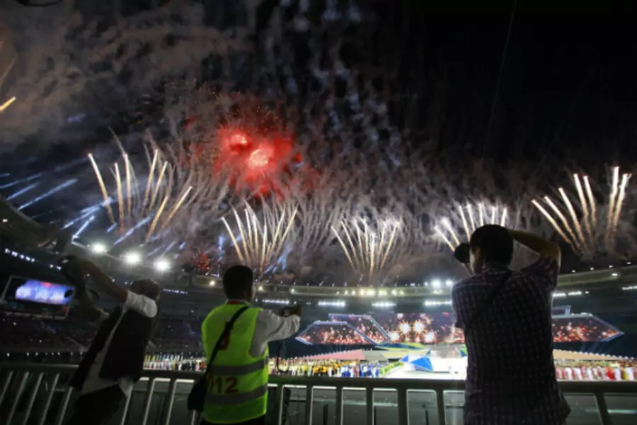 People take photos as fireworks are released during the opening ceremony of the 27th SEA Games in Naypyitaw December 11, 2013. Myanmar is hosting the games for the first time in over 40 years. (Soe Zeya Tun/Courtesy Reuters)