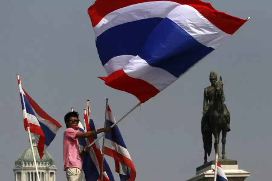 An anti-government protester waves a Thai national flag during a rally at the Royal Plaza near the Government House in Bangkok on December 9, 2013. (Chaiwat Subprasom/Courtesy Reuters)