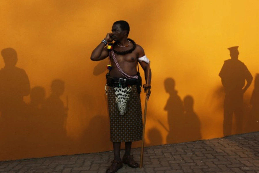 A man dressed in traditional attire speaks on a cell phone in Ludzidzini, Swaziland, August 2010 (Courtesy Reuters/Siphiwe Sibeko).