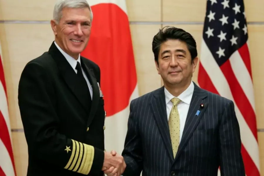 Admiral Samuel J. Locklear (L), Commander of U.S. Pacific Command, shakes hands with Japan's Prime Minister Shinzo Abe at the start of their talks at the Abe's official residence in Tokyo February 3, 2014