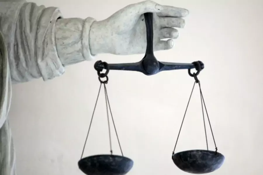 The Scales of Justice, France, 2009 (Courtesy Reuters/Stephane Mahe).