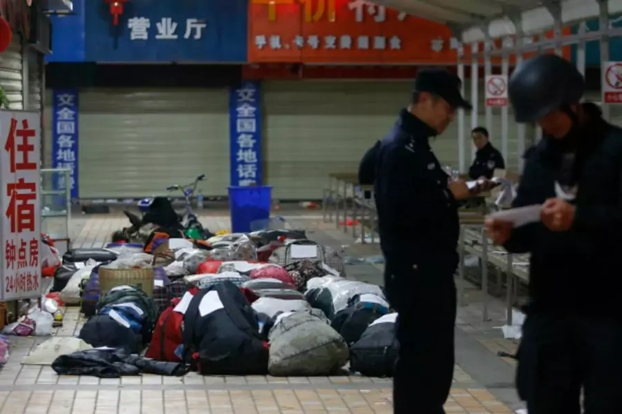 Policemen check unclaimed luggage at a square outside the Kunming railway station after a knife attack, in Kunming, Yunnan province on March 2, 2014. (Stringer/Courtesy Reuters)