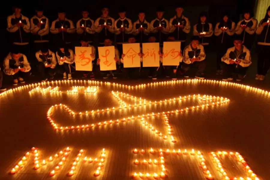 International school students light candles to pray for passengers aboard Malaysia Airlines flight MH370, in Zhuji, Zhejiang province, on March 10, 2014. (Stringer/Courtesy Reuters)
