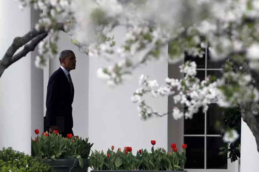 U.S. President Barack Obama walks among Cherry Blossoms in the Rose Garden of the White House in Washington March 20, 2012. (Jason Reed/Courtesy Reuters)