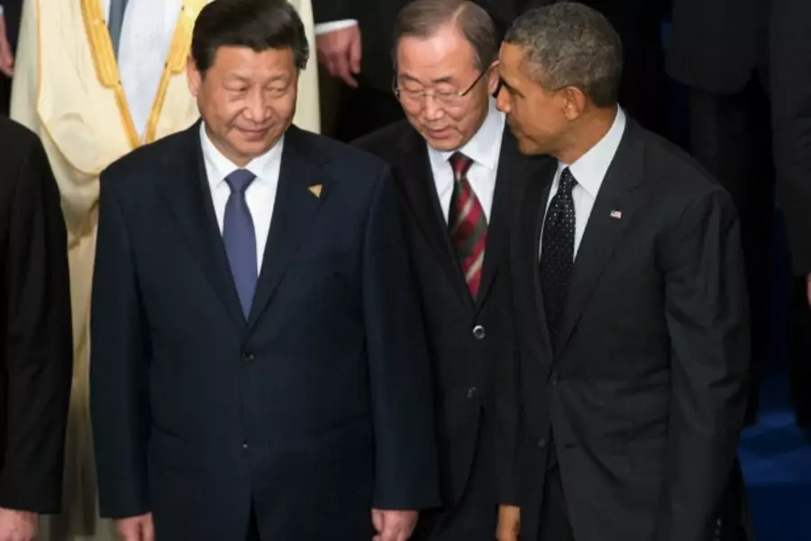 U.S. President Barack Obama, U.N. Secretary-General Ban Ki-moon and China's President Xi Jinping talk during a family photo at the Nuclear Security Summit in The Hague March 25, 2014. (Doug Mills/Courtesy Reuters)