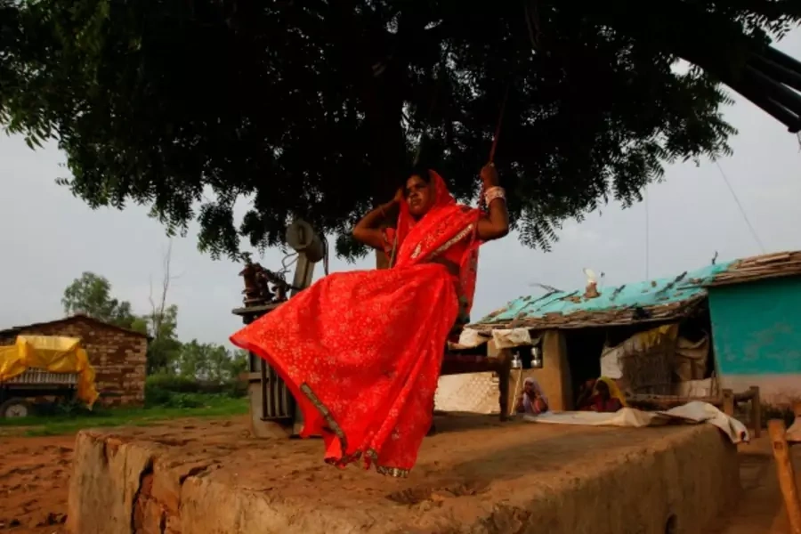 Child bride Krishna, 12, plays on an improvised swing outside her house in a village near Baran, India, July 2011 (Courtesy Reuters/Danish Siddiqui).