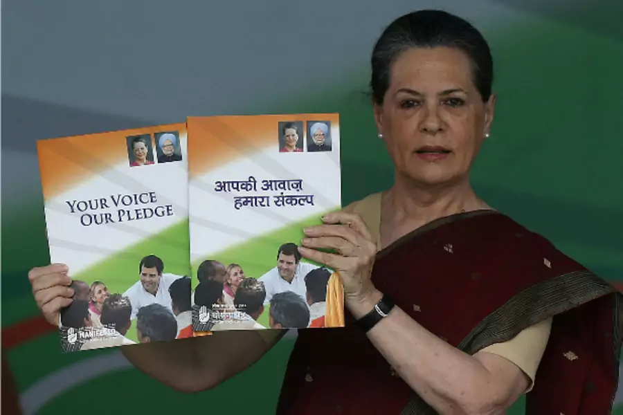 Chief of India's ruling Congress party Sonia Gandhi holds her party's manifesto for the April/May general election in New Delhi March 26, 2014 (Adnan Abidi/Courtesy Reuters).