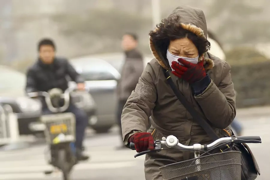 Chinese woman struggles with air pollution