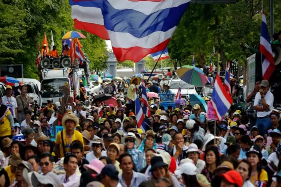 Anti-government protesters wait for their leader Suthep Thaugsuban to come out from the parliament building to address them in...ister Yingluck Shinawatra out of office and an anti-graft agency indicted her for negligence (Damir Sagolj/Courtesy: Reuters).