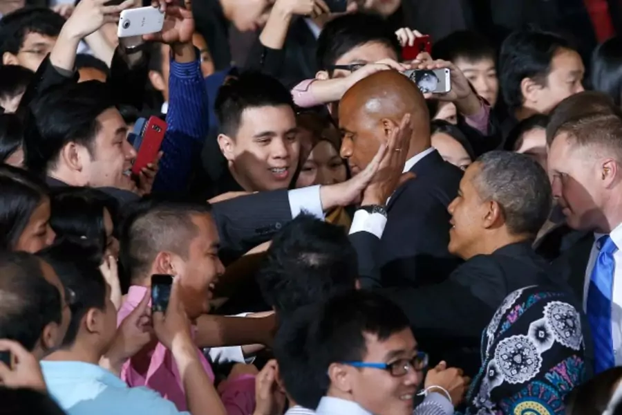 U.S. President Barack Obama high fives a member of the audience as he leaves after the Young Southeast Asian Leadership Intiat...Hall inside the University of Malaya in Kuala Lumpur April 27, 2014. REUTERS/Samsul Said (MALAYSIA - Tags: POLITICS EDUCATION)