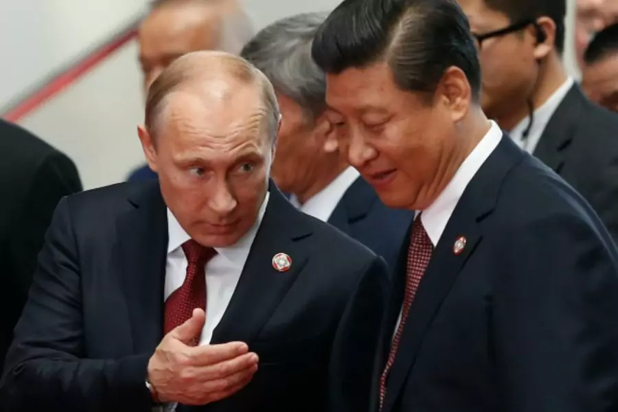 Russia's President Vladimir Putin (L) and his Chinese counterpart Xi Jinping talk before the opening ceremony of the fourth Conference on Interaction and Confidence Building Measures in Asia (CICA) summit in Shanghai May 21, 2014. REUTERS/Aly Song