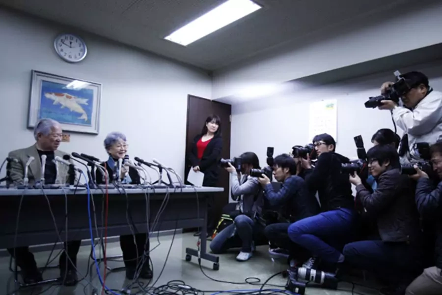 Photographers take pictures of Shigeru Yokota (L) and his wife Sakie (C), parents of Megumi Yokota who was abducted by North Korea agents at age 13 in 1977, during a news conference in Kawasaki, west of Tokyo, March 17, 2014