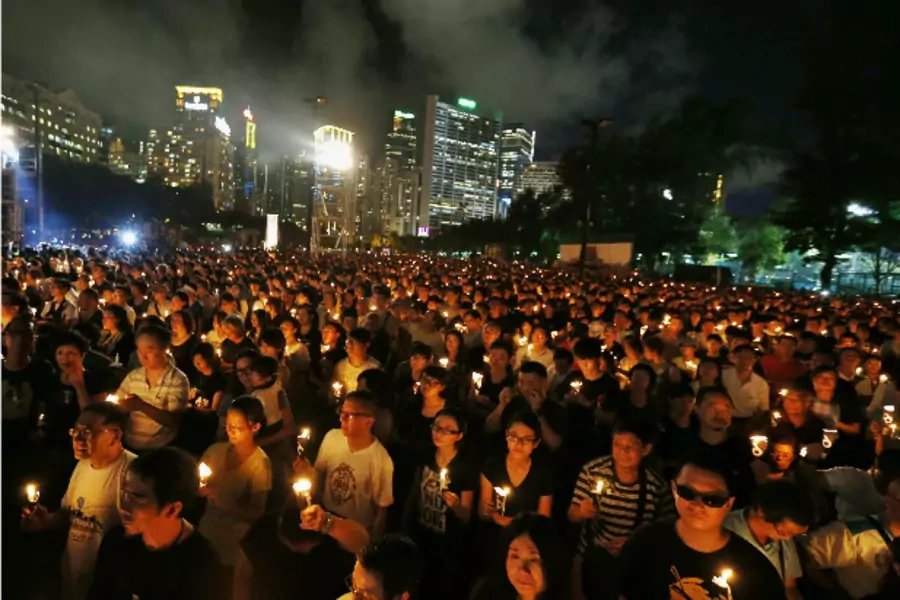 Tens of thousands of people take part in a candlelight vigil at Hong Kong's Victoria Park on June 4, 2014, to mark the 25th an...y of the military crackdown on the pro-democracy movement at Beijing's Tiananmen Square in 1989 (Bobby Yip/Courtesy: Reuters).