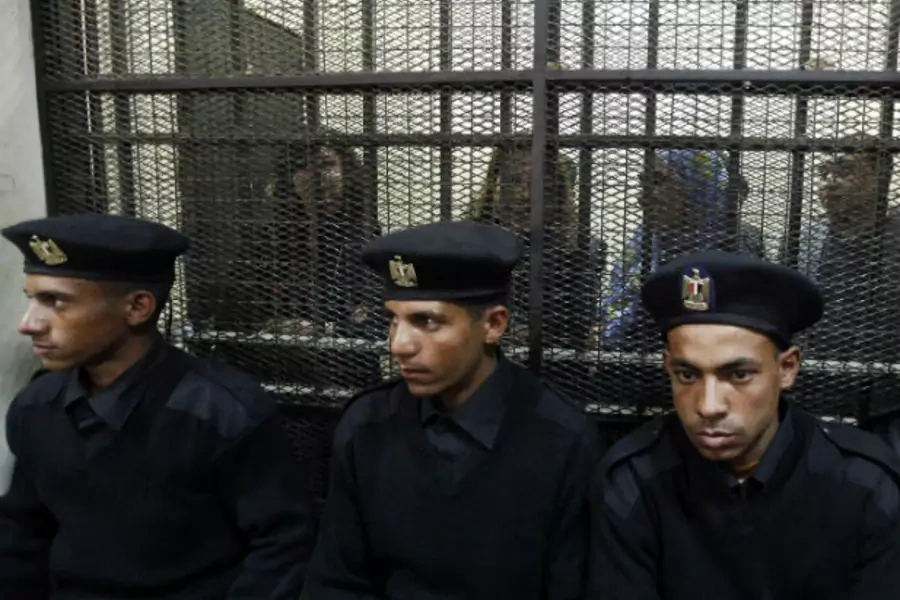 Egyptian activists accused of working for outlawed non-governmental organizations stand trial in Cairo in February 2014.